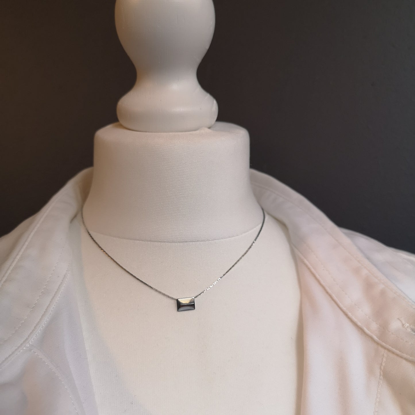 Finesse, the classic metal plate necklace.