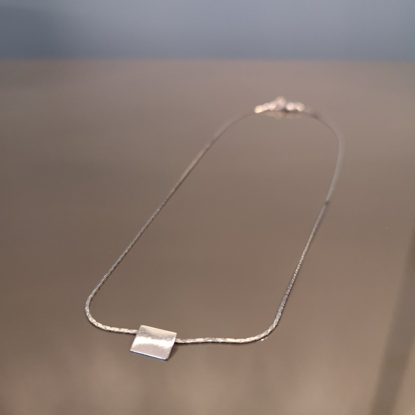 Finesse, the classic metal plate necklace.