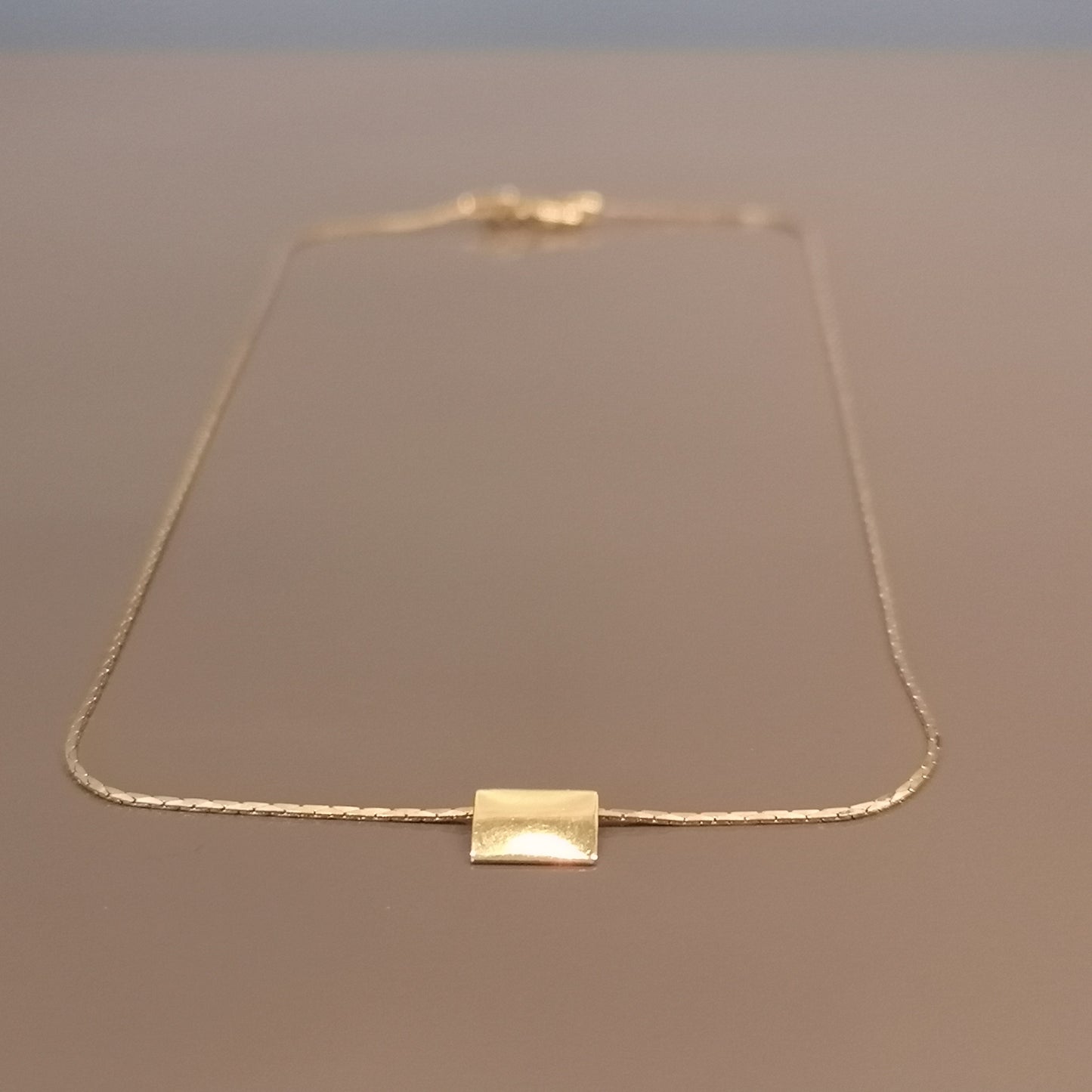 Finesse, the classic metal plate necklace.