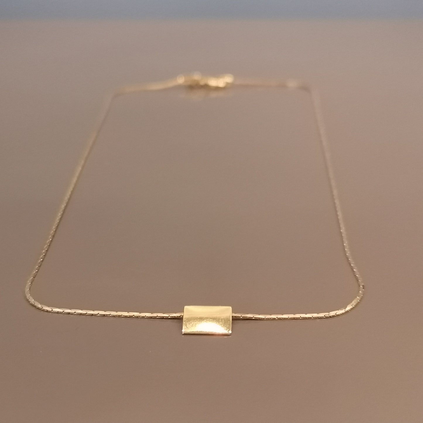 Finesse, the classic metal plate necklace.
